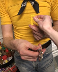 a man with a yellow shirt is holding a key